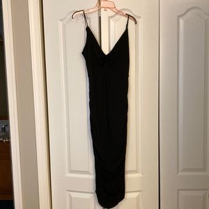 NWT black stretchy dress. Strappy v front and back. Excellent little black dress